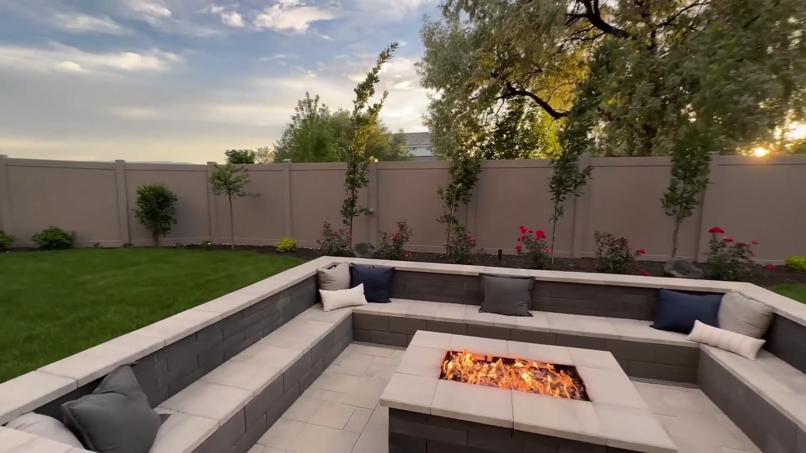 Sunken fire pit with built-in seating on the lawn
