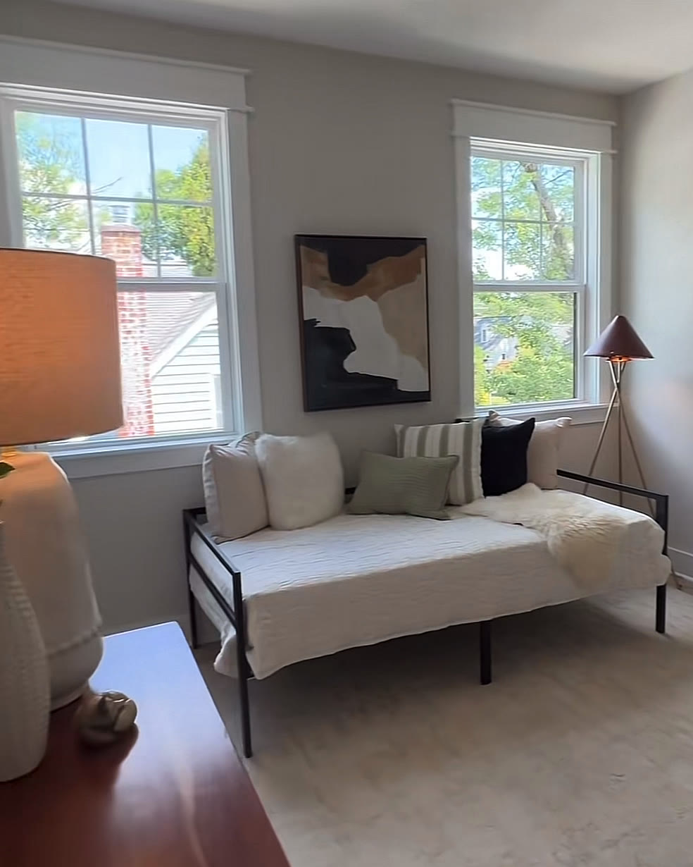 Bright bedroom with a daybed, desk and two windows