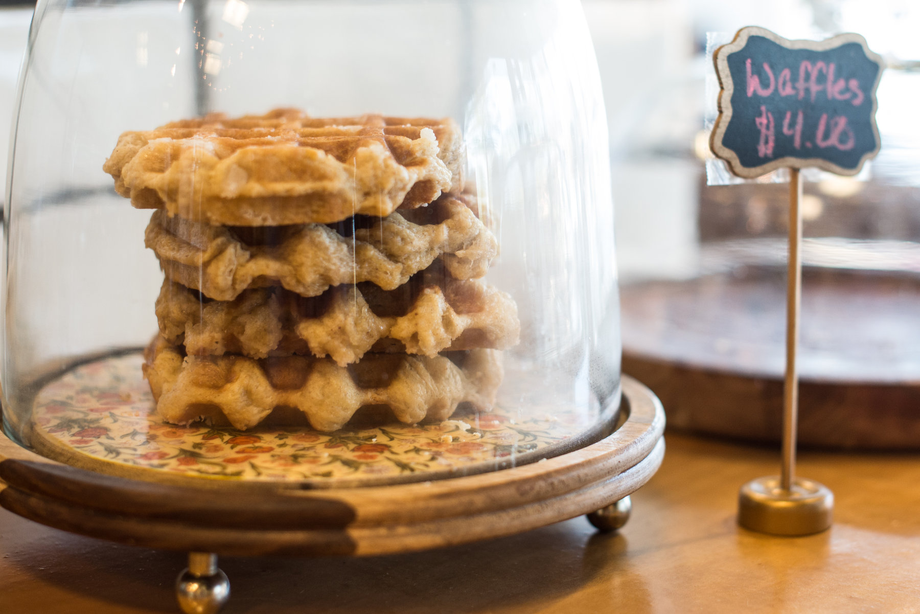 Stack of Belgian waffles under a glass dome
