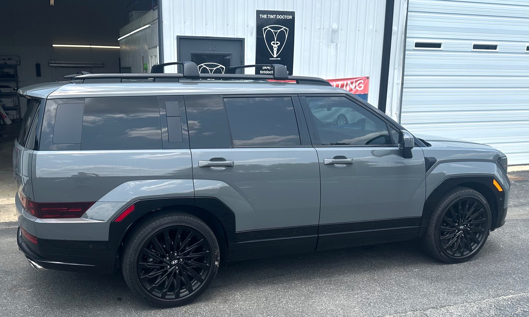 Grey SUV with tint outside The Tint Doctor shop