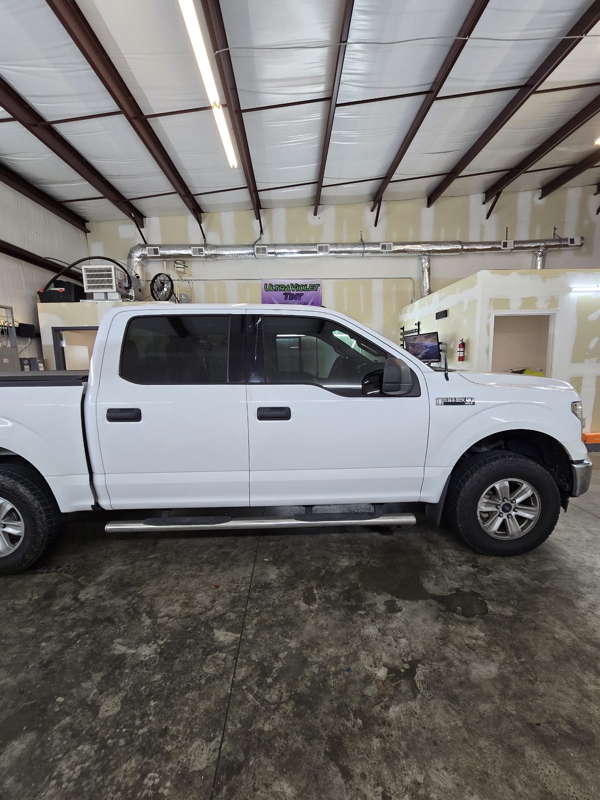 White Ford F-150 with tinted windows in the bay