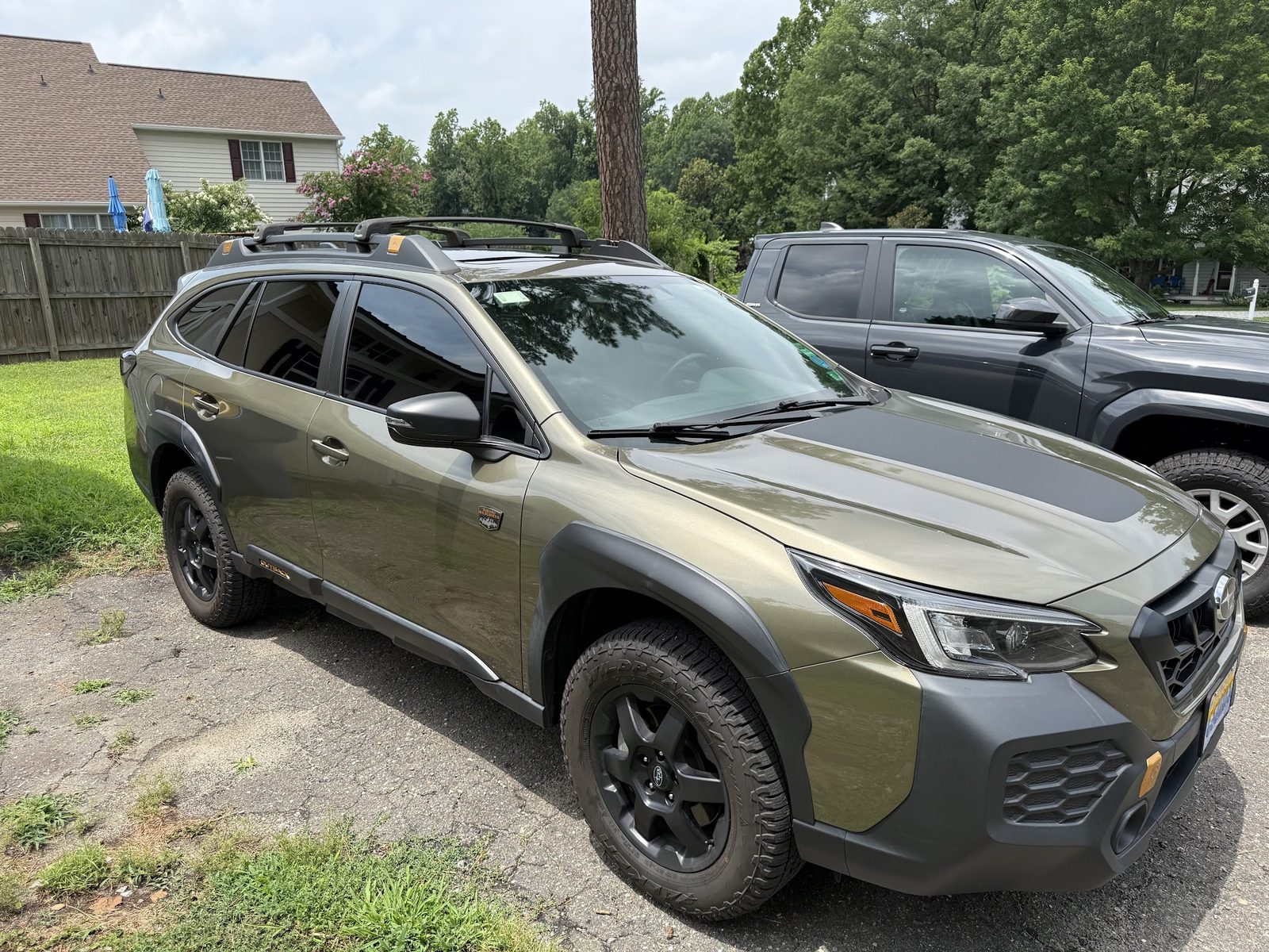 Green Subaru Outback with tinted windows