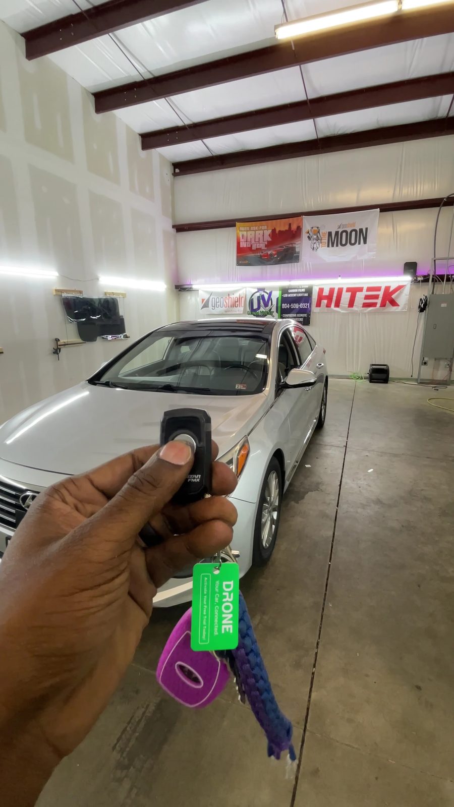 Remote start key fob held up in the UltraViolet Tint bay